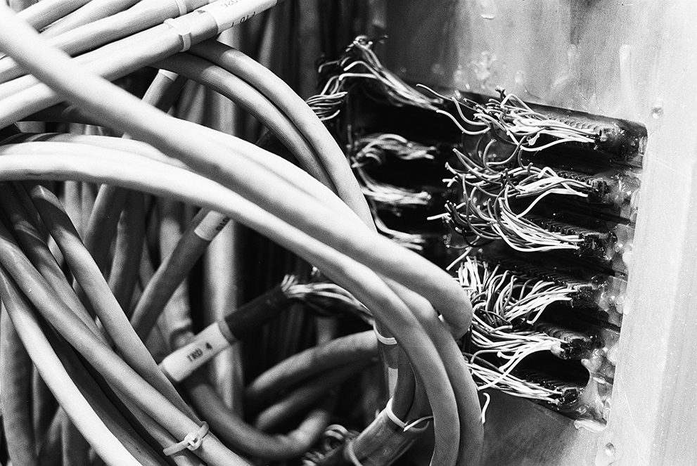 A dozen serial ports on which the cables were just cut off. Shot on Fomapan 100 classic.