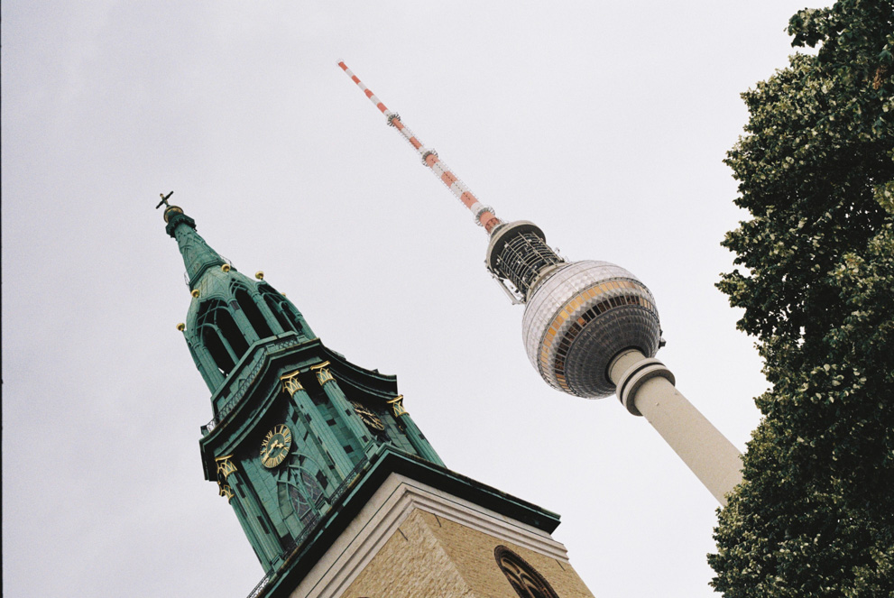 The Berlin TV tower and the St Marien bell tower in a dutch angle. Shot on Kodak ColorPlus 200.